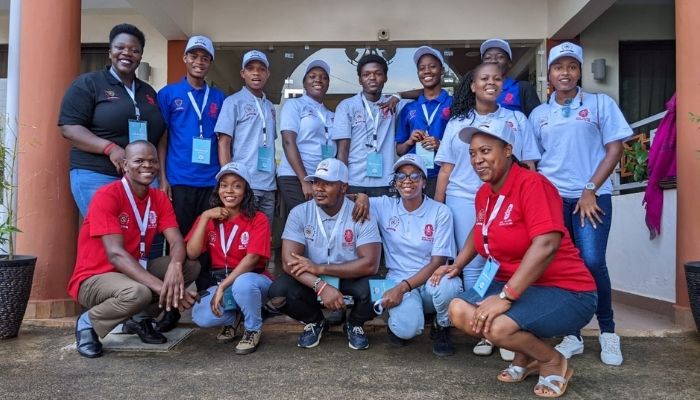 A group of young people pose for a photograph while contributing to the Zero Malaria Starts with Me campaign.